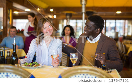 Man and woman chatting while having dinner in restaurant Man and woman chatting while having dinner in restaurant 137647501