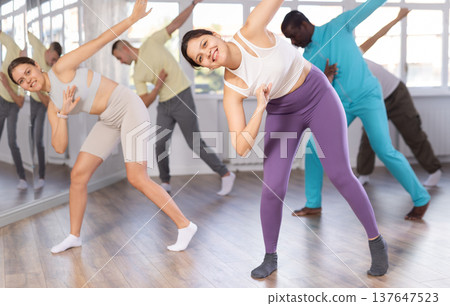 Young Asian woman learning modern street dancing in studio Young Asian woman learning modern street dancing in studio 137647523