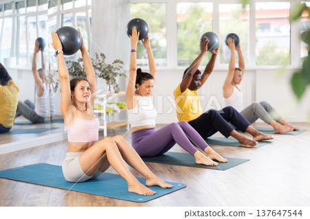 Group of men and women doing pilates with softball 137647544