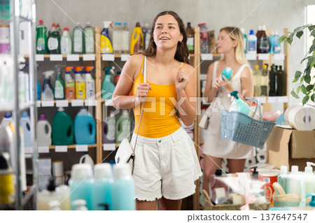 Young girl in summer clothes looking around other choosing something Young girl in summer clothes looking around other choosing something 137647547