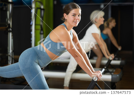 Woman doing exercises for gluteal muscles and legs Woman doing exercises for gluteal muscles and legs 137647573