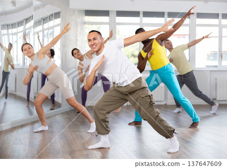 European guy with team of like-minded multinational people learn to elements of hip hop dance European guy with team of like-minded multinational people learn to elements of hip hop dance 137647609