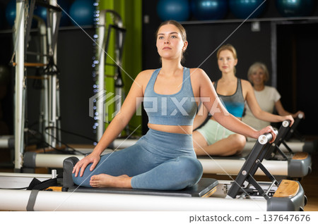 Portrait of a woman on a reformer Portrait of a woman on a reformer 137647676