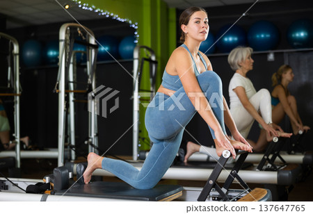 Woman doing leg workout on reformer 137647765