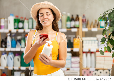 Young woman scanning qr code for sunscreen 137647787