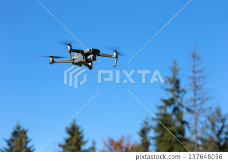 The drone copter flying with digital camera. The drone copter flying with digital camera. 137648056