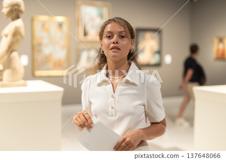 Girl walks around museum hall, view exhibition items Girl walks around museum hall, view exhibition items 137648066