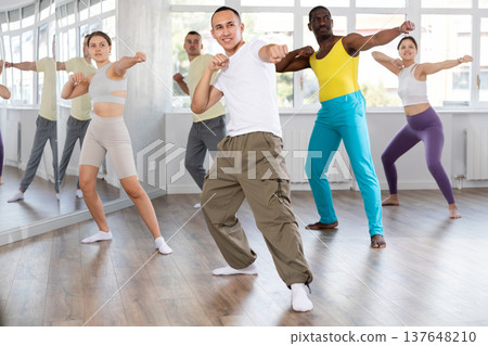 Young Asian man practicing Capoeira dance in training hall Young Asian man practicing Capoeira dance in training hall 137648210