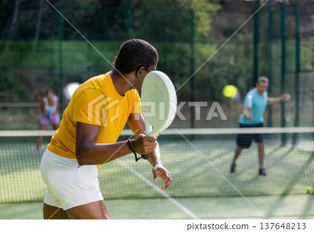 African american man padel tennis player trains on the court African american man padel tennis player trains on the court 137648213