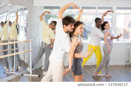 Man and young woman dancing waltz in couple during lesson at studio 137648217