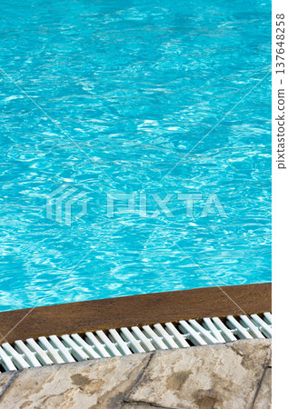 Blue pool water with sun reflections 137648258