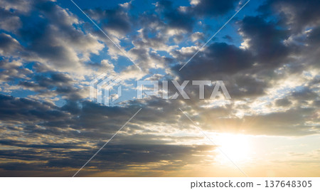 Sunset with sun rays, sky with clouds and sun. Sunset with sun rays, sky with clouds and sun. 137648305