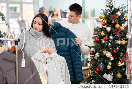 Couple customer choose down jacket, New Year atmosphere Couple customer choose down jacket, New Year atmosphere 137648355