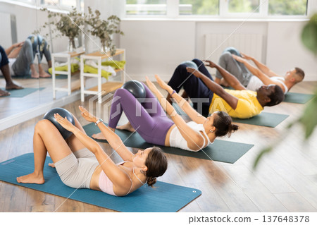 Group of men and women doing pilates with softball 137648378