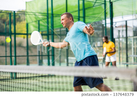European man padel tennis player trains on the court 137648379