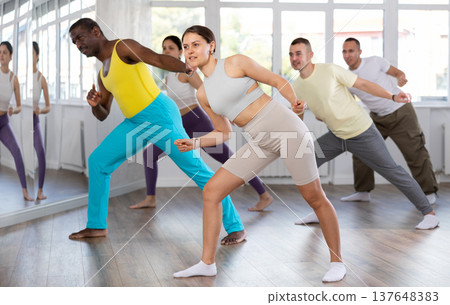 Group of people dancing modern dances Group of people dancing modern dances 137648383