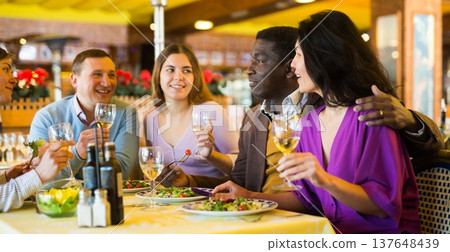 Happy adult people having fun in restaurant during dinner Happy adult people having fun in restaurant during dinner 137648439