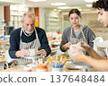 Young woman and man and elderly man crafting ceramics 137648484