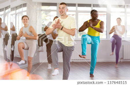 European guy with team of like-minded multinational people learn to elements of hip hop dance European guy with team of like-minded multinational people learn to elements of hip hop dance 137648515
