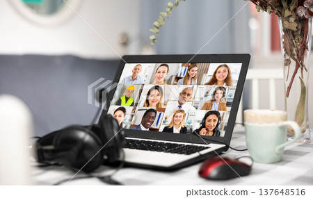 Image of a laptop turned on, lying on a table Image of a laptop turned on, lying on a table 137648516