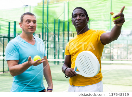 Men talking after padel match outdoors Men talking after padel match outdoors 137648519