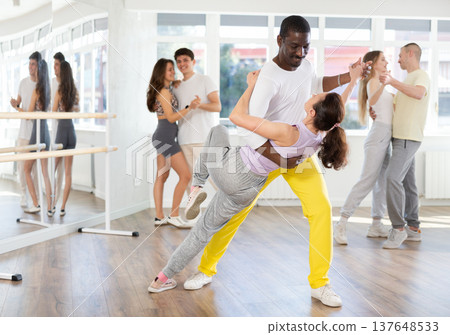 Woman dances incendiary tango with African man partner during choreography lesson 137648533