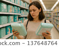 Woman choosing baby diapers in supermarket aisle 137648764