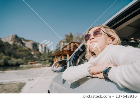 Woman in Sunglasses Enjoying a Road Trip Woman in Sunglasses Enjoying a Road Trip 137648930