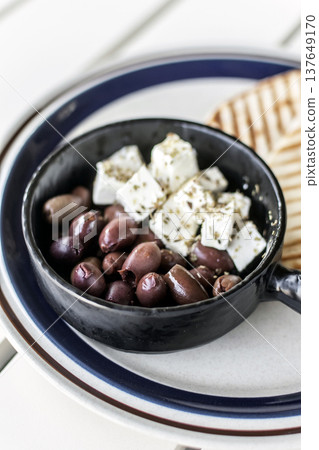 marinated olives and feta cheese tapas snack at outdoor restaurant in mykonos greece marinated olives and feta cheese tapas snack at outdoor restaurant in mykonos greece 137649170