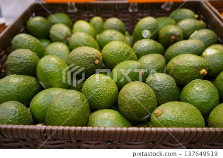 Fresh Green Avocados in Basket at Farmers Market Fresh Green Avocados in Basket at Farmers Market 137649519