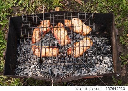 Warm, rustic tones highlight perfectly charred chicken, radiating a sense of home cooking and delightful indulgence Warm, rustic tones highlight perfectly charred chicken, radiating a sense of home cooking and delightful indulgence 137649620