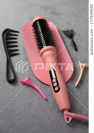 High tech pink electric hair styler with intelligent heat control. Ceramic ionic technology for damage free styling. Complete set with comb and clips for professional results at home 137649689