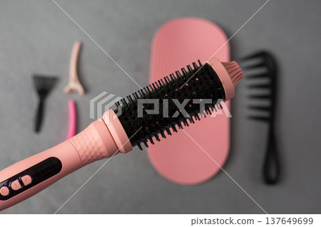 Professional pink electric hair styler set for beauty supply business. Complete kit with round brush, comb, mat, and clips in retail packaging. Perfect for small beauty shops and online stores Professional pink electric hair styler set for beauty supply business. Complete kit with round brush, comb, mat, and clips in retail packaging. Perfect for small beauty shops and online stores 137649699