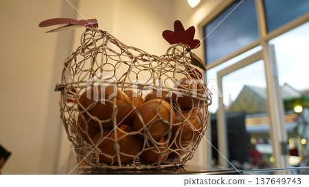 Chicken Wire Basket Full of Eggs Still Life Image 137649743