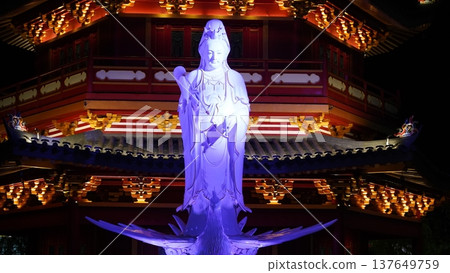 Guanyin Statue at Night Illuminated in Purple Light Guanyin Statue at Night Illuminated in Purple Light 137649759