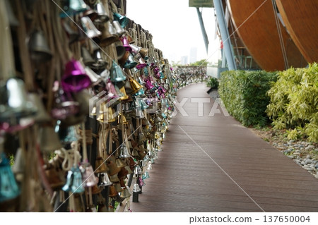 Path with Many Bells Hanging on Ropes on a Bridge Path with Many Bells Hanging on Ropes on a Bridge 137650004