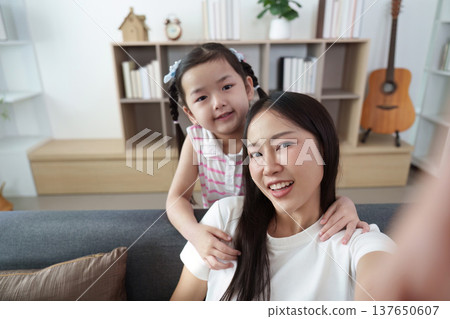Mother and daughter sharing joyful moment at home 137650607