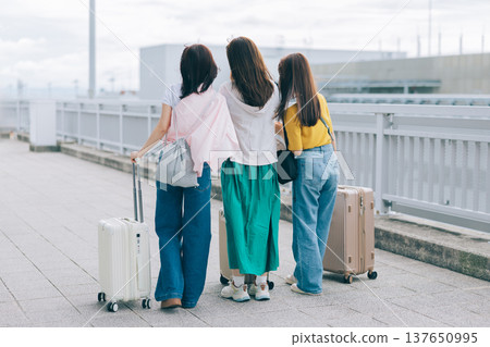 Three women at the airport. "Filming assistance provided by: Kansai International Airport (KIX)" Three women at the airport. "Filming assistance provided by: Kansai International Airport (KIX)" 137650995