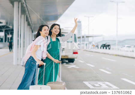 Two women waiting for a taxi (bus) while traveling. (Photography provided by Kansai International Airport (KIX)) 137651062