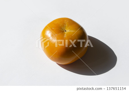 It is Persimmon lying on a white background 137651154