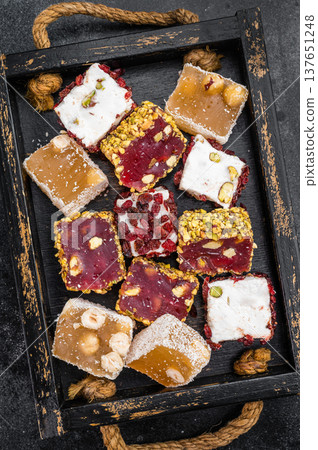 Colorful Turkish delight assortment with pistachio hazelnut and coconut. Gourmet jelly dessert top view. Colorful Turkish delight assortment with pistachio hazelnut and coconut. Gourmet jelly dessert top view. 137651248