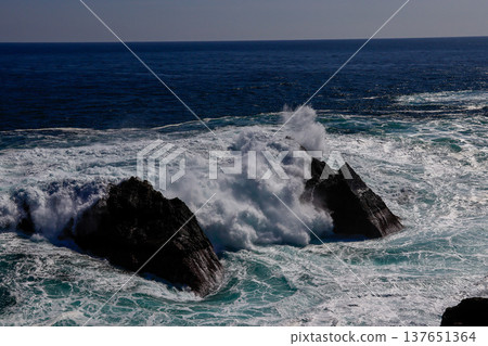 Rough waves crashing against the shore Rough waves crashing against the shore 137651364