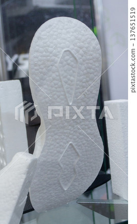 White sole of sports shoes. Products made from foamed polymers expanded polypropylene EPP and expanded polystyrene EPS. Model of dense and lightweight material, universal foam. New modern technologies White sole of sports shoes. Products made from foamed polymers expanded polypropylene EPP and expanded polystyrene EPS. Model of dense and lightweight material, universal foam. New modern technologies 137651519