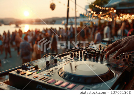 Beach party with a DJ at sunset. View of the summer nightlife. 137651568