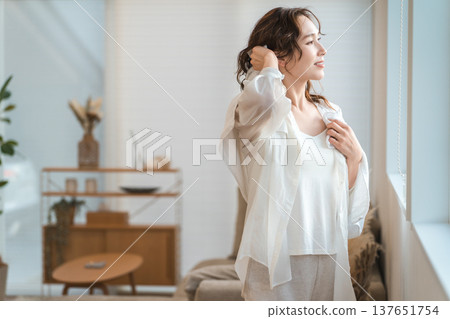 Asian woman towel drying her hair after a bath or shower 137651754