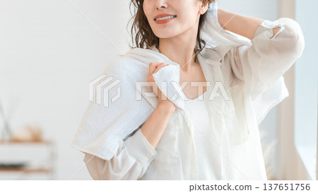 Asian woman towel drying her hair after a bath or shower 137651756