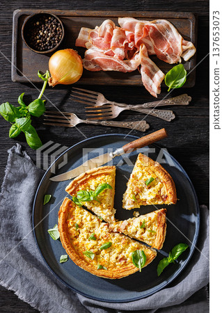 Quiche Lorraine with bacon, cheese and fresh basil 137653073