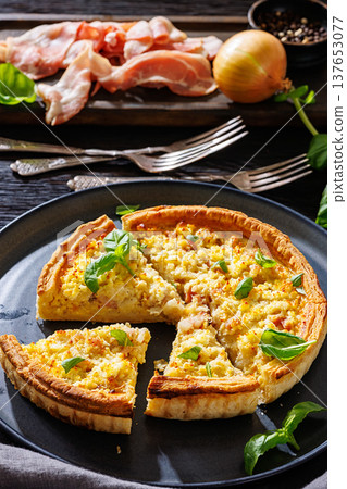 Quiche Lorraine with bacon, cheese and fresh basil 137653077