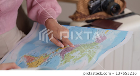 Exploring Destinations. Woman studying map for travel planning. Exploring Destinations. Woman studying map for travel planning. 137653216