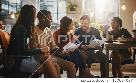 Candid moment with friends discussing ideas in a bright, modern workspace during an afternoon gathering Candid moment with friends discussing ideas in a bright, modern workspace during an afternoon gathering 137654057